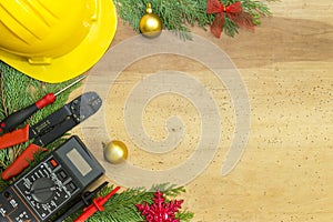 Electrician tools and instruments and Christmas decorations on wooden background