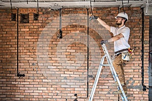 Electrician with tools, working on a construction site. Repair and handyman concept