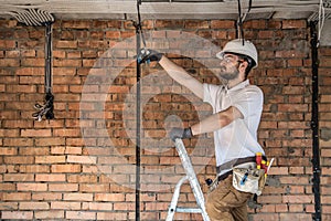 Electrician with tools, working on a construction site. Repair and handyman concept