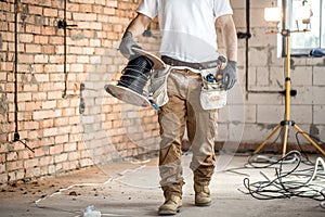 Electrician with tools, working on a construction site. Repair and handyman concept