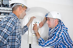 Electrician training an apprentice