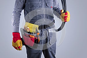 Electrician in uniform with wires. Repair electrical system concept.