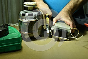 An electrician uses pliers to cut the motor wires.