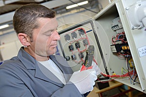electrician using cable strippers
