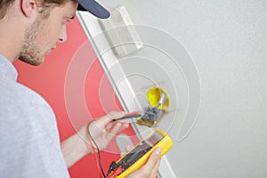 Electrician using multi meter