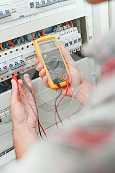 Electrician using multi meter