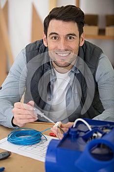 electrician using screwdriver on electrical junction box