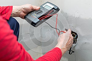 Electrician using voltmeter