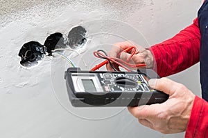 Electrician using voltmeter