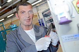 electrician using wire strippers