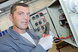 electrician using wire strippers photo