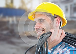 Electrician with wires cables on building site