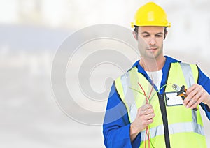 Electrician with wires cables on building site