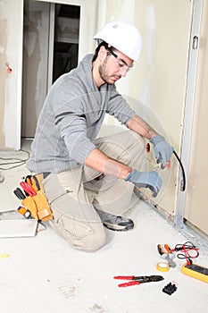 Electrician wiring a house