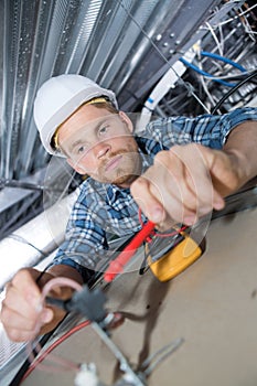 Electrician wiring in roof space