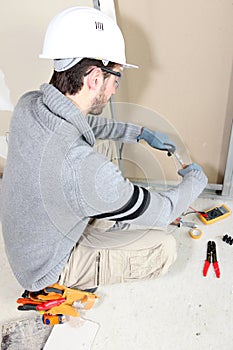 Electrician wiring a room