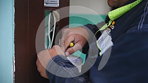 Electrician wiring up a switch indoor, close up