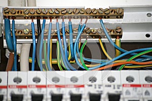 Electrician work connecting cables at control box