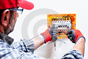 Electrician at work on an electrical panel.