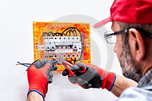 Electrician at work on an electrical panel.