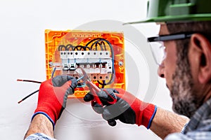 Electrician at work on an electrical panel.