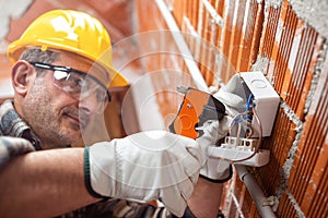 Electrician at work in an electrical system of a construction site. Construction industry