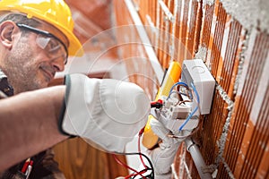 Electrician at work in an electrical system of a construction site. Construction industry