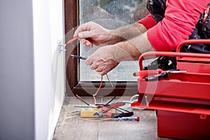 Electrician at work, home renovation, electrical installation, Hand of an electrician, handyman at work