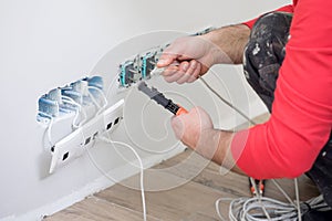 Electrician at work, home renovation, electrical installation, Hand of an electrician, handyman at work photo