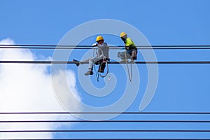 Electrician work installation of high voltage cable in high voltage safely and systematically over and blue sky background