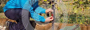 Electrician at work installing and repairing the photocell of an automatic gate