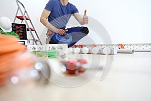 Electrician at work with nippers and wires in hand, shows the thumb like, install lamps at home, electric circuits,