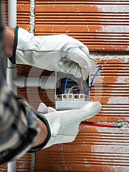 Electrician at work on a residential electrical system. Electricity