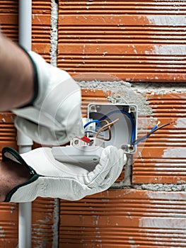 Electrician at work on a residential electrical system. Electricity