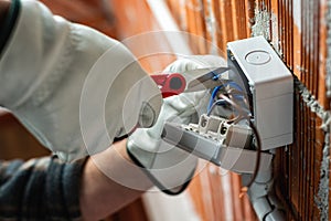 Electrician at work on a residential electrical system. Electricity