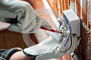 Electrician at work on a residential electrical system. Electricity