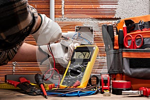 Electrician at work on a residential electrical system. Electricity