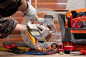 Electrician at work on a residential electrical system. Electricity