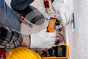 Electrician at work on a residential electrical system. Electricity