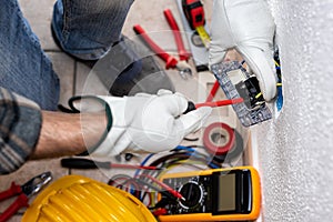 Electrician at work on a residential electrical system. Electricity