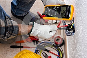 Electrician at work on a residential electrical system. Electricity