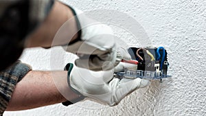 Electrician at work on a residential electrical system. Electricity