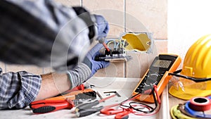 Electrician at work with safety equipment on a residential electrical system. Electricity.