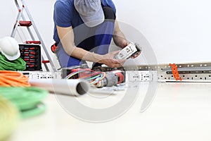 Electrician at work with socket, install electric circuits, electrical wiring