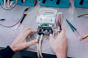 Electrician worker checking electricity meters. Electrical equipment.