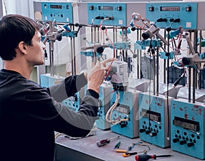 Electrician worker checking electricity meters. Electrical equipment.