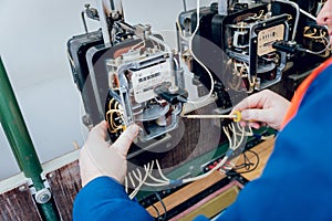 Electrician worker checking electricity meters. Electrical equipment.