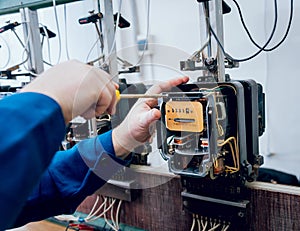 Electrician worker checking electricity meters. Electrical equipment.