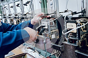 Electrician worker checking electricity meters. Electrical equipment.