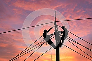 Electrician worker climbing electric power pole to repair the damaged power cable line problems after the storm. Power line